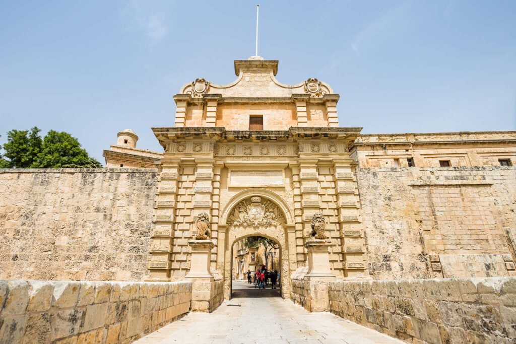 Detailed architecture adorns the ancient gate and walls of Mdina.