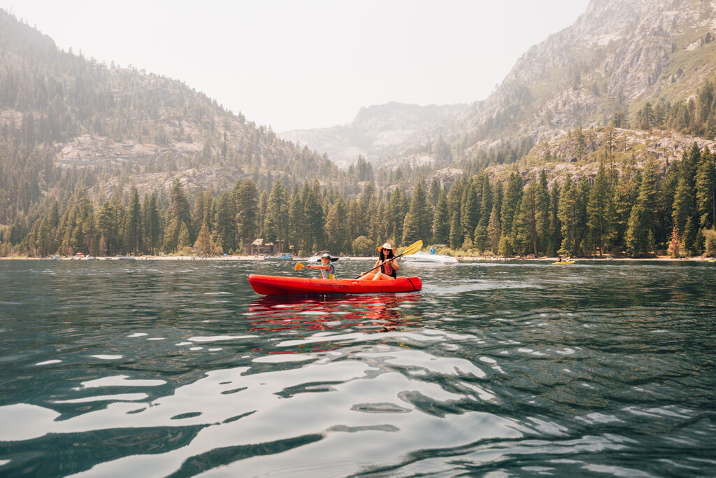 Mother and son in a tandem kayak on Lake Tahoe.