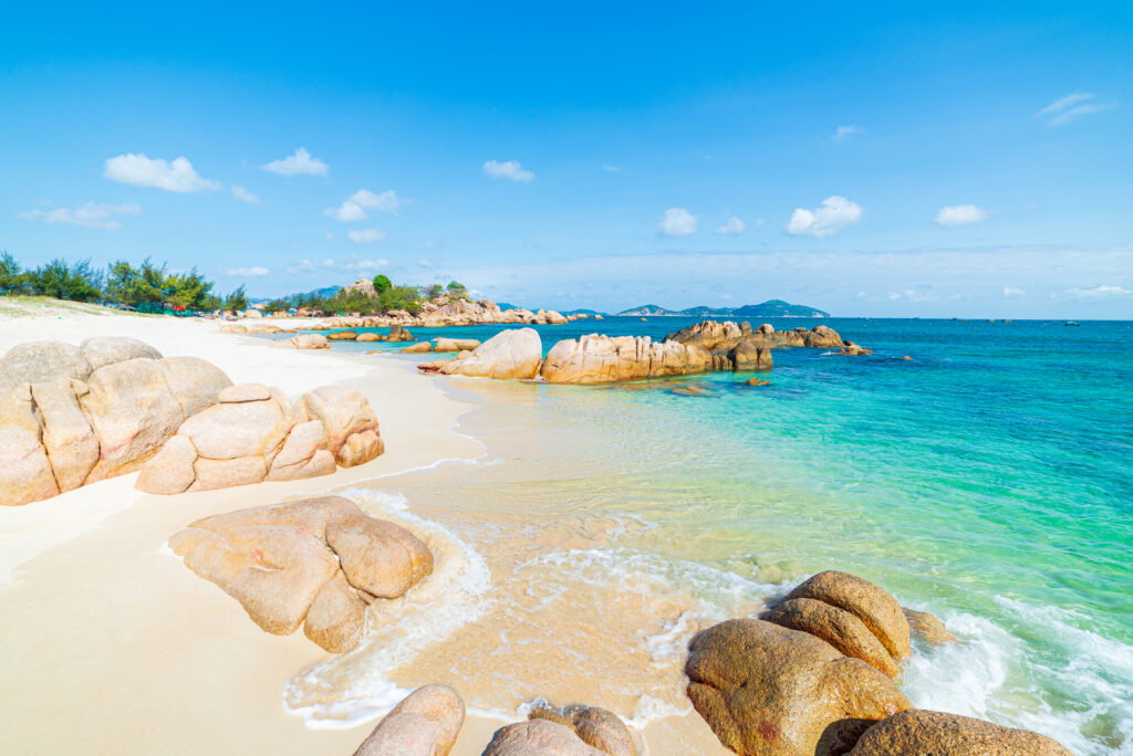 Gorgeous tropical beach turquoise transparent water unique rock boulders, Cam Ranh Nha Trang Vietnam south east coast travel destination, desert beach no people clear blue sky