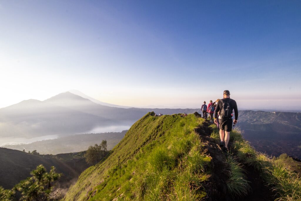 Hiking around the crater of Mount Batur with Mount Agung in the background