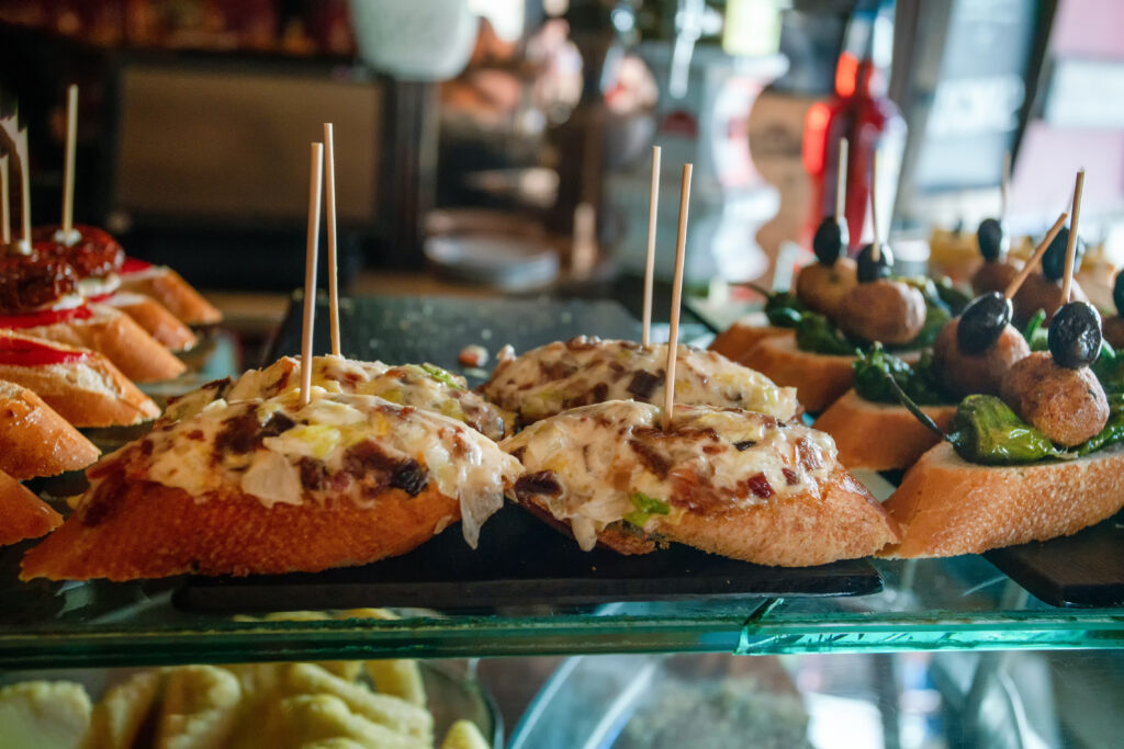 Tapas are Spanish appetizers, meant to be eaten in just a few bites. Traditional tapas include mixed olives, fried baby squid, neatballs and chorizo in cafe of Barcelona or Madrid or Valencia or Murcia or Malaga or Zaragoza or Seville